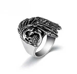 Macro shot of vintage mens ring featuring skull and Indian feather textures with oxidized finish