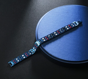 Detail view of blue stainless steel therapy bracelet with multi-colored magnetic inserts