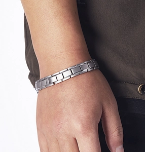 Macro detail of men's matte silver titanium steel link bracelet with folding clasp