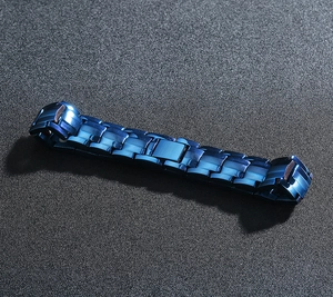 Detail shot of navy blue stainless steel chain link bracelet with matte brushed metal texture