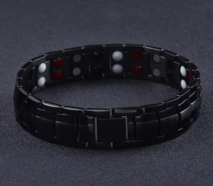 Detail of polished black magnetic therapy bracelet featuring double row energy stone inlays