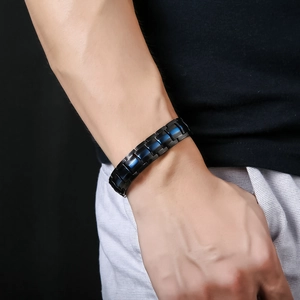 Men's double row magnetic stainless steel bracelet in black and blue links worn on wrist