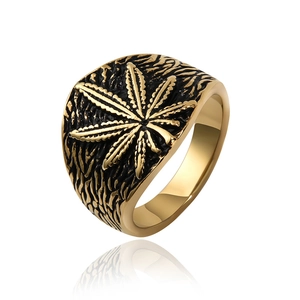 Detailed macro view of retro black and gold cannabis leaf relief on men's titanium ring