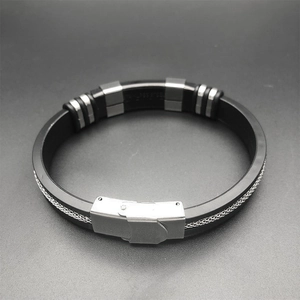 Detail of black silicone bracelet with parallel steel chains and polished metal clasp