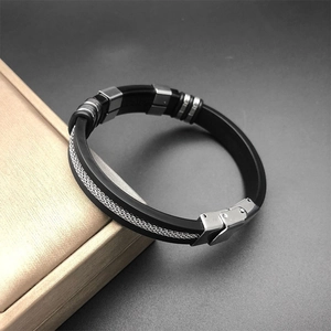 Macro detail of men's industrial silicone bracelet with stainless steel mesh and clasp