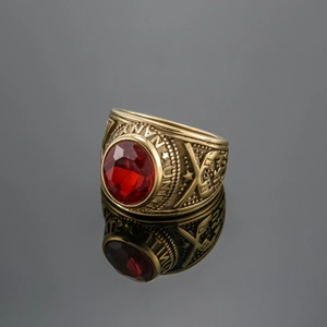 Detailed macro view of gold US Army military ring with large faceted red oval gemstone