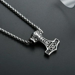 Close-up of stainless steel Mjölnir pendant with intricate Celtic knotwork details