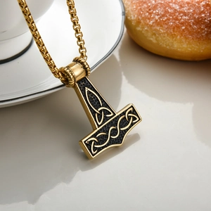 Golden Mjölnir Thor's Hammer necklace with Celtic knots on a modern square box chain