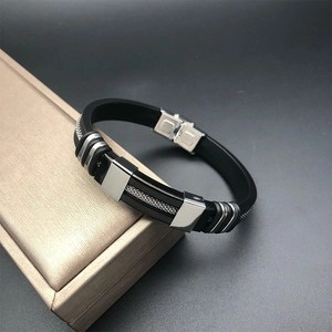 Men's black silicone bracelet with silver stainless steel mesh inlay on a display box