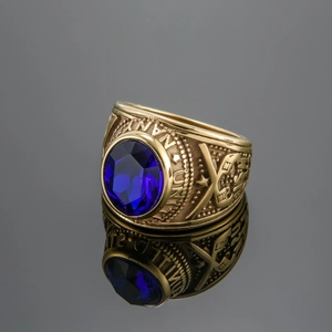 Close-up of gold military ring with blue oval gemstone and Navy emblem engravings