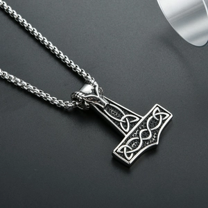 Detail of Thor's hammer pendant with ram head and Celtic knot in vintage steel