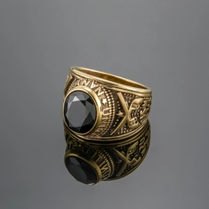 Macro shot of United States Navy gold military ring with black gemstone and reflections