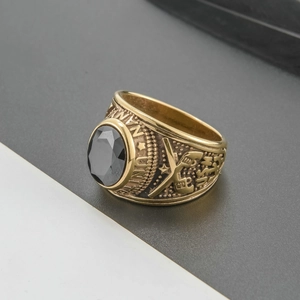 Detailed macro of vintage gold men's military ring with oval black stone and engraving
