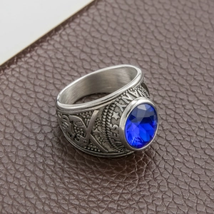 Close-up of vintage United States Navy ring with blue gemstone and anchor engraving