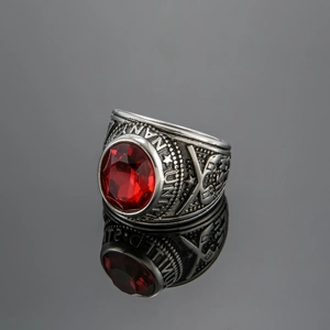 Detail of US Navy men's ring with red faceted stone and engraved silver vintage band