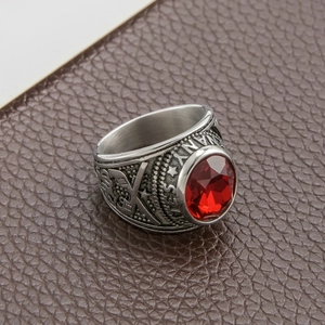 Detail of vintage steel ring featuring large red stone and engraved star with NY logo