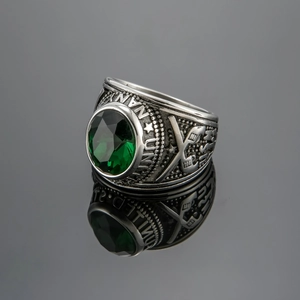 Detailed macro view of vintage United States Navy ring with large emerald green gemstone
