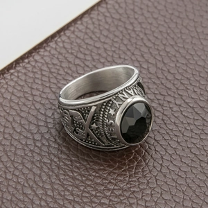Macro view of vintage stainless steel army ring featuring a black faceted stone and eagle crest