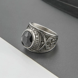 Macro view of vintage silver military ring featuring a black gemstone and side carvings