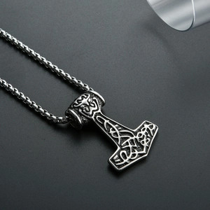 Close-up of vintage Thor's Hammer pendant with Nordic Celtic knots on a box chain