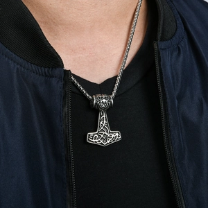 Close-up of a Viking Thor's Hammer Mjölnir pendant worn on a silver square link chain