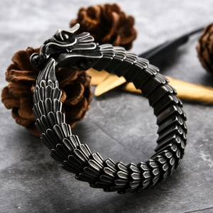 Retro dragon scale stainless steel bracelet with detailed dragon head clasp on stone background