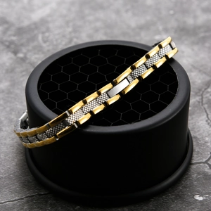 Detail eines zweifarbigen Edelstahl-Gliederarmbands mit Goldglanz und Silberstruktur