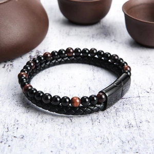 Detail of red tiger eye stone beads and black braided leather strap with magnetic clasp
