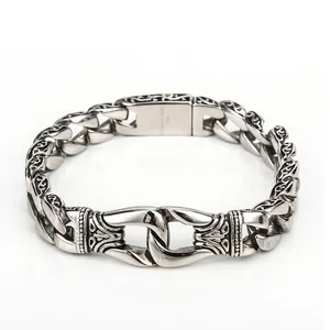 Retro stainless steel men's bracelet with intricate carved links and a polished finish