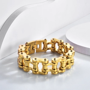 Close-up of golden stainless steel motorcycle chain bracelet with secure buckle