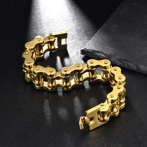 Macro detail of golden mechanical bike chain bracelet with heavy duty folding clasp