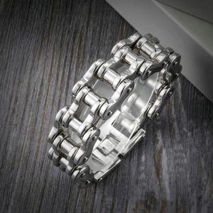 Polished silver stainless steel motorcycle chain bracelet for men on dark wood
