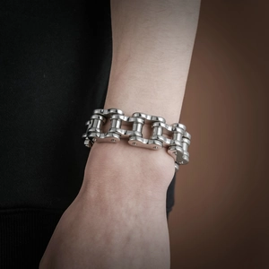 Detail of masculine stainless steel biker chain bracelet on wrist with heavy metallic texture
