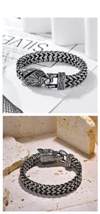 Close-up of a Nordic Viking wolf head clasp and braided stainless steel chain for men