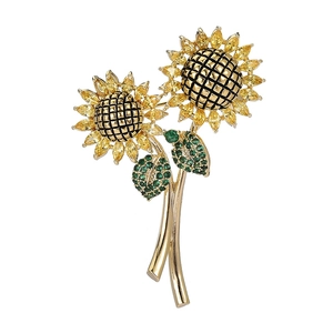 Elegante spilla a girasole con pietre preziose gialle e cristalli verdi su stelo dorato
