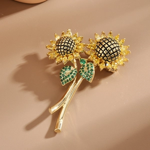 Elegante spilla a girasole con cristalli gialli e foglie verdi su base dorata