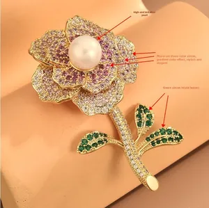 Detailed macro view of floral brooch with colorful zircons and large white shell pearl