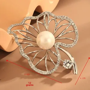 Detail view of leaf brooch featuring micro-set zircon and 5.4cm x 4.1cm dimensions