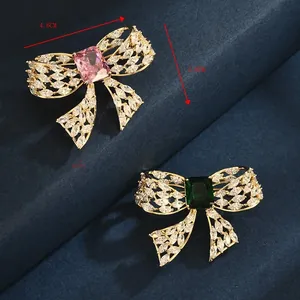 Detailed macro view of 4.6cm bow brooches with pink and green zircon stones