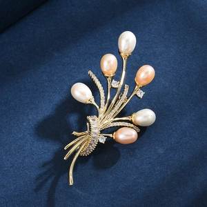 Elegant gold flower bouquet brooch with freshwater pearls and sparkling zircons