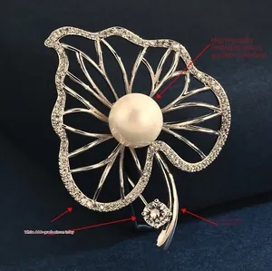 Detail of leaf brooch with large shell pearl, AAA white zircons, and polished copper base