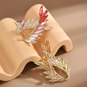 Elegant gold olive branch brooch with colorful crystals and marquise-cut gemstones