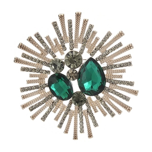 Macro shot of large emerald and smoke grey crystal brooch with golden radial rays