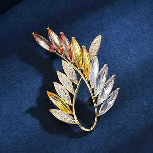 Elegant olive branch brooch with orange crystal gradient in gold finish for jackets