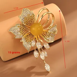 Detail of flower brooch with yellow pearl and crystals, measuring 4.6cm by 6.2cm