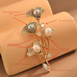 Détails de la broche feuille de ginkgo avec perles grises et blanches et oxydes de zircone