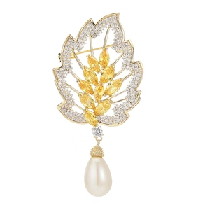 Elegant leaf brooch with yellow marquise gems, micro-paved zircons, and drop pearl