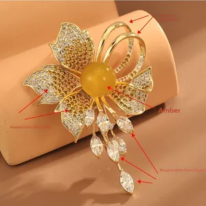 Detailed macro view of vintage flower brooch with amber resin and gradient cubic zirconia