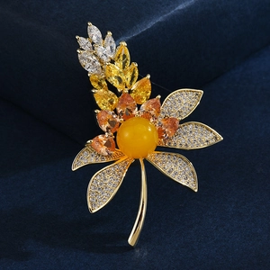 Elegant gold wheat leaf brooch with amber yellow bead and marquise cubic zirconia