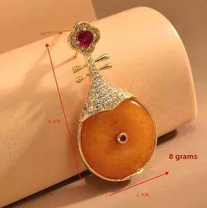 Détail broche Pipa avec pierre orange et pavé de zircons blancs, taille 4,2x2,3 cm